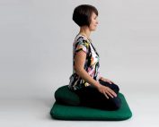 Woman sitting meditating with good posture